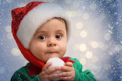 Image of Cute baby in Christmas costume against blurred lights, closeup