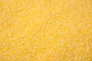 Raw corn grits as background, closeup view