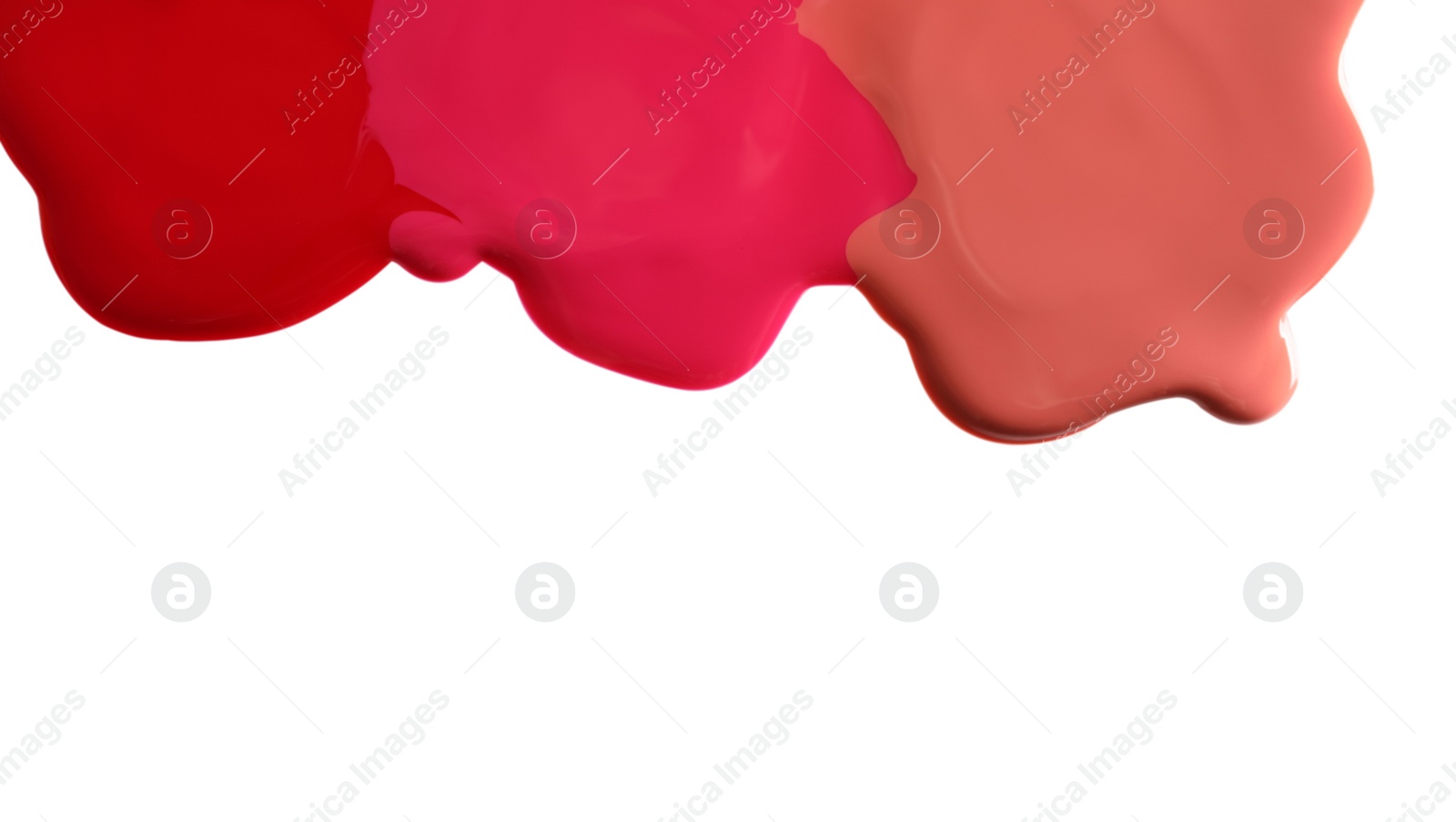 Photo of Different color nail polishes flowing on white background