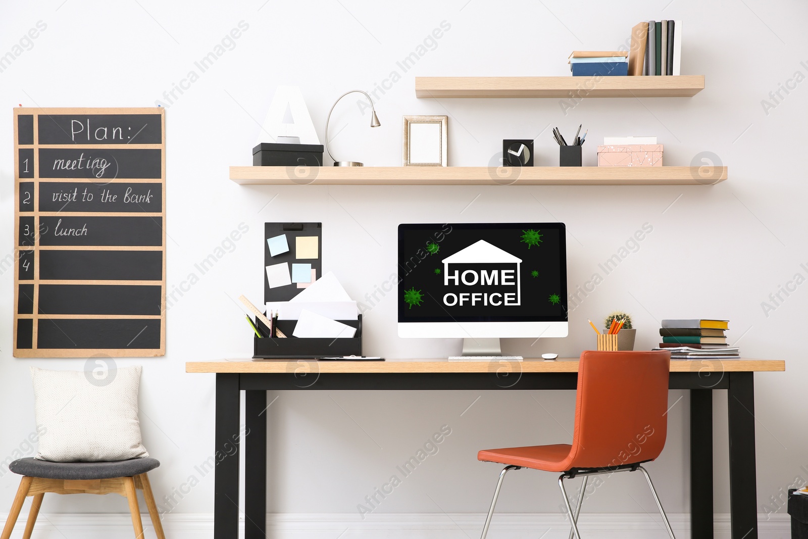 Image of Modern computer with text HOME OFFICE on wooden table indoors