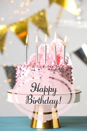 Happy Birthday! Delicious cake with burning candles on blue wooden table