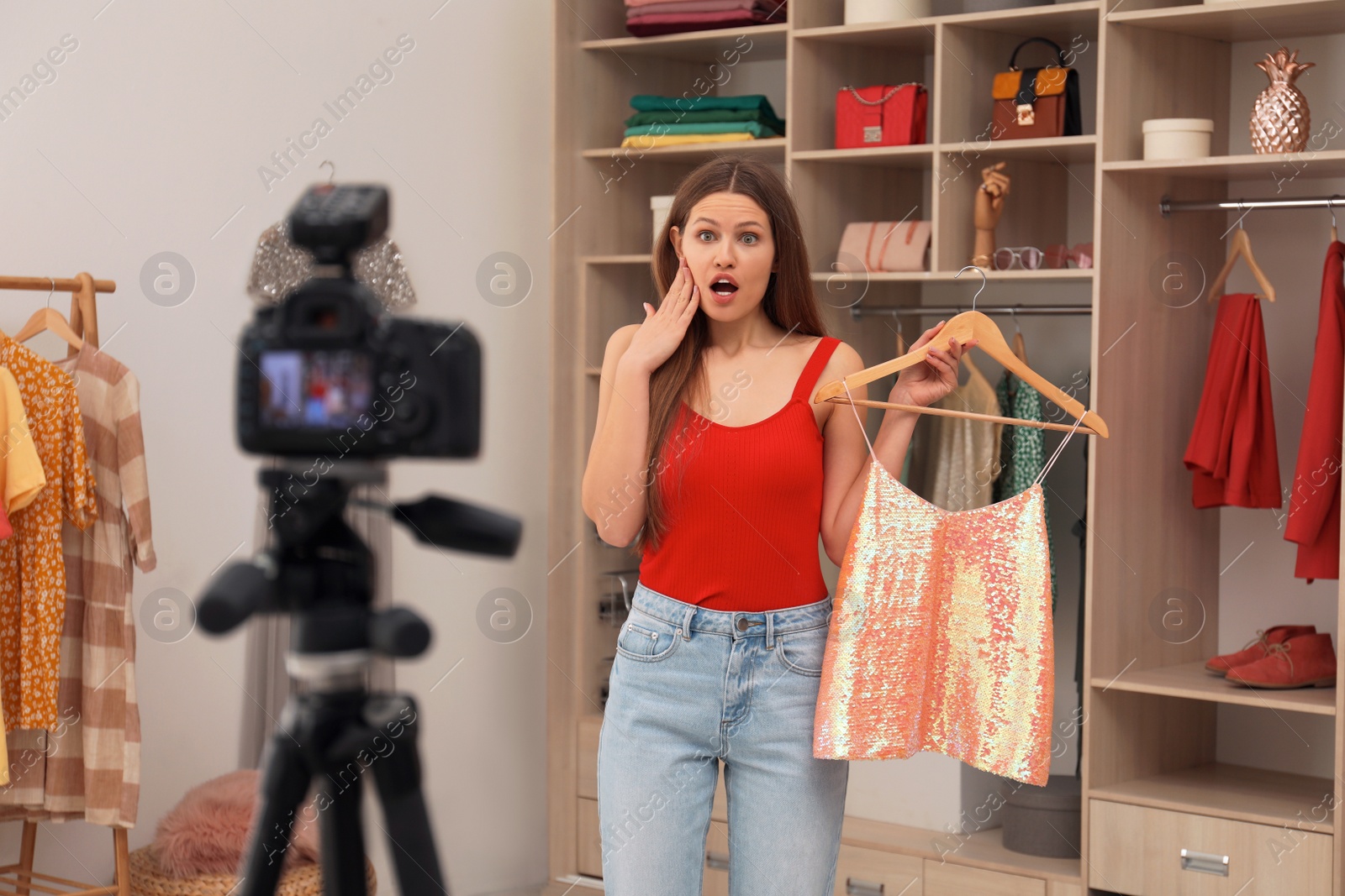 Photo of Emotional fashion blogger recording new video in room