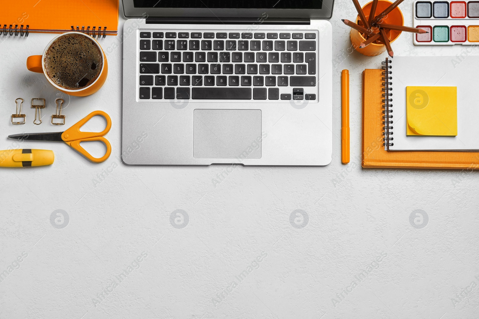 Image of Flat lay composition with modern laptop and orange stationery on white table