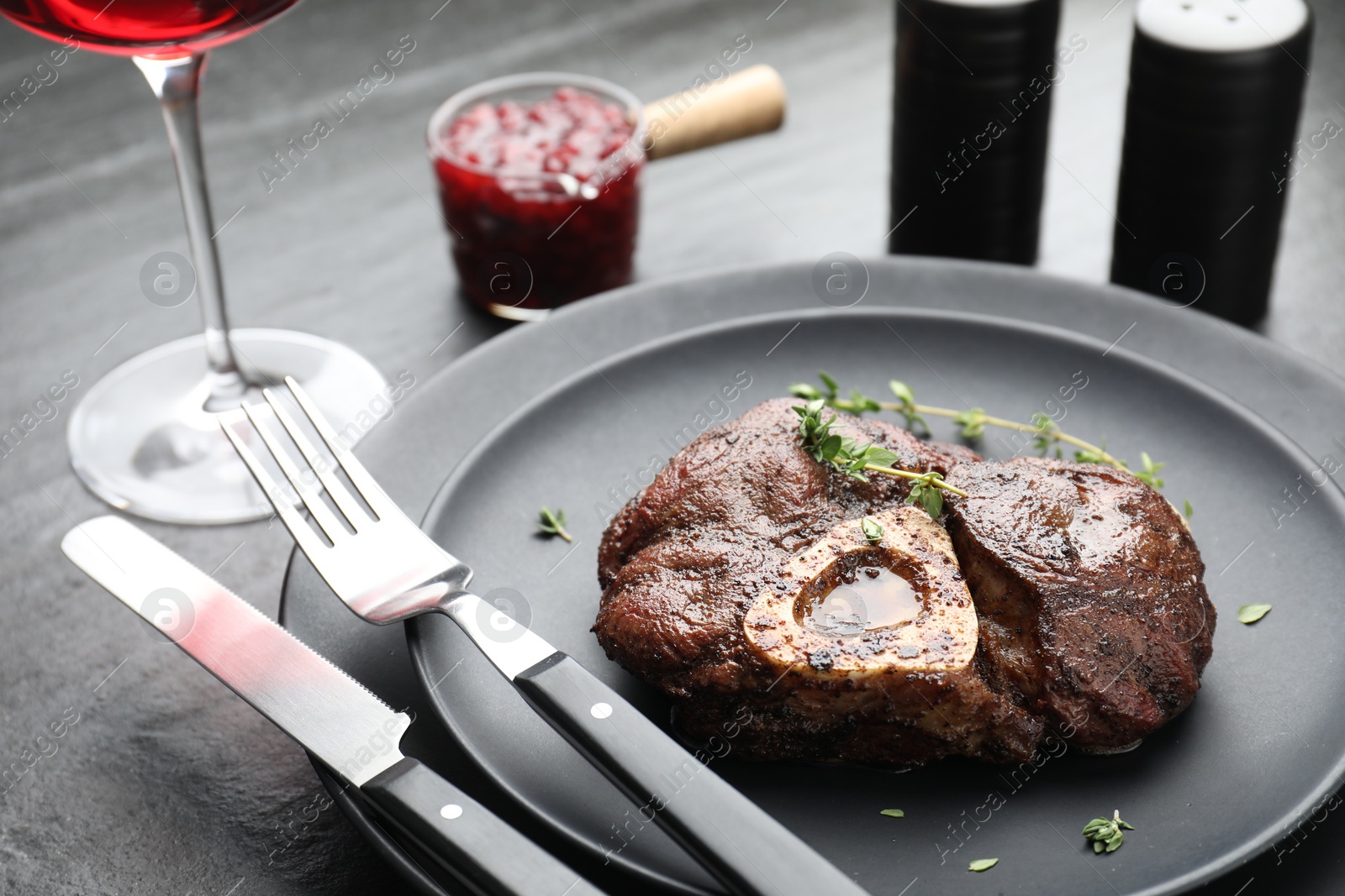 Photo of Tasty grilled beef meat served on black table, closeup