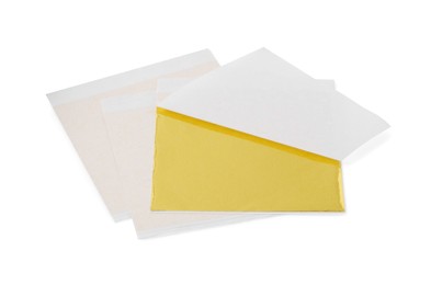 Photo of Many edible gold leaf sheets on white background