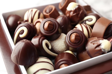 Photo of Different tasty chocolate candies, closeup