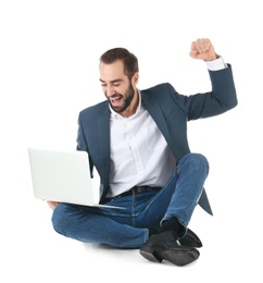 Emotional businessman in office wear with laptop celebrating victory on white background