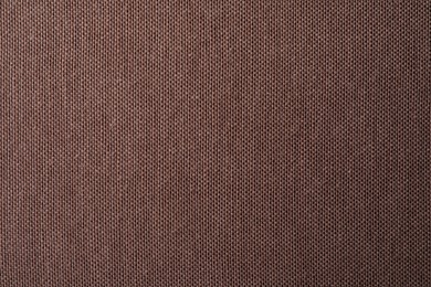 Photo of Texture of brown fabric as background, top view