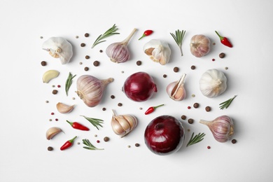 Composition with garlic, peppers and onions on white background, top view