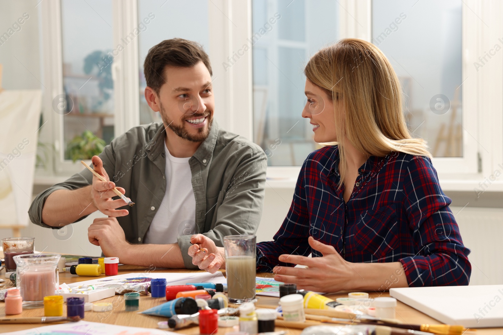 Photo of Students attending painting class in studio. Creative hobby