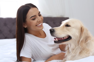 Happy woman with her cute pet dog at home