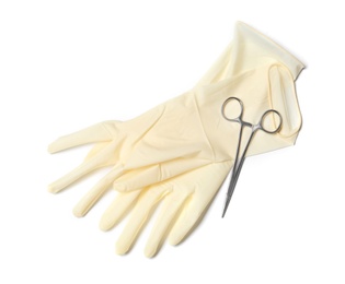 Protective gloves and medical clamp on white background, top view