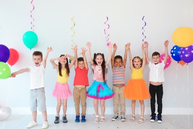 Photo of Adorable little children at birthday party indoors