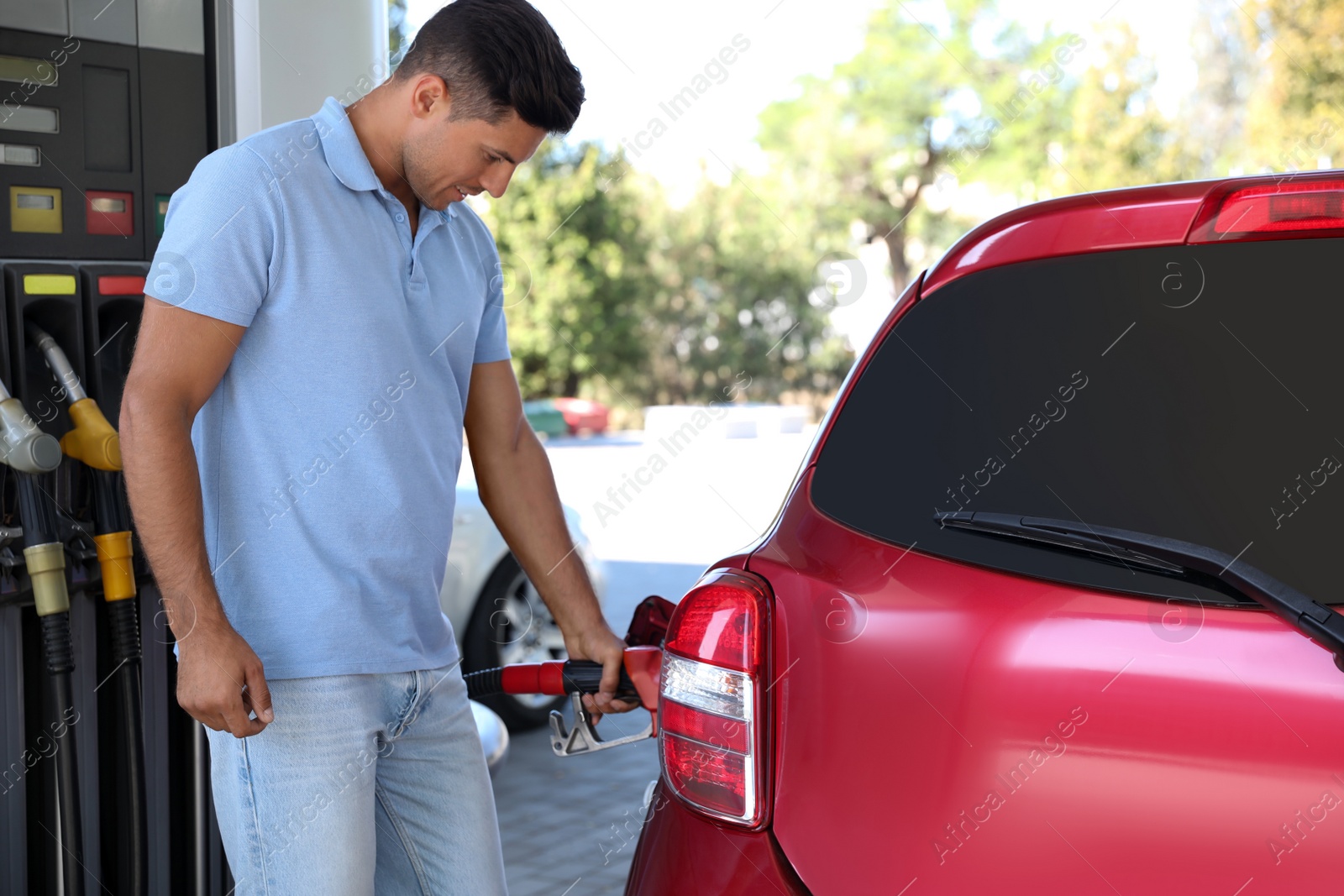 Photo of Man refueling car at self service gas station