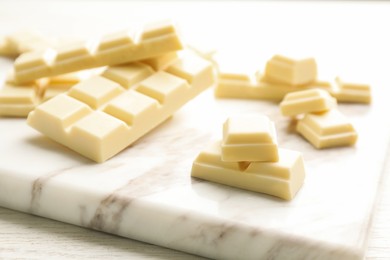 Delicious white chocolate on wooden table, closeup