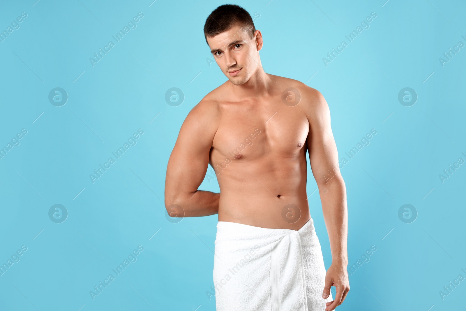 Photo of Young man with slim body on light blue background