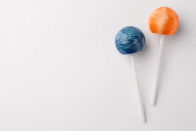 Tasty lollipops on white background, flat lay. Space for text