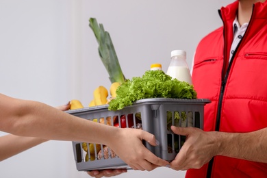 Man delivering food to customer indoors, closeup