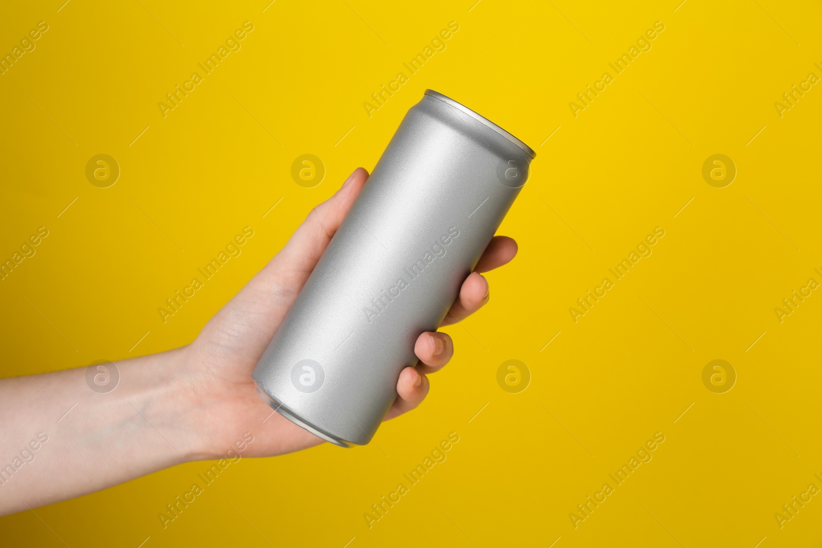 Photo of Woman with energy drink on yellow background, closeup