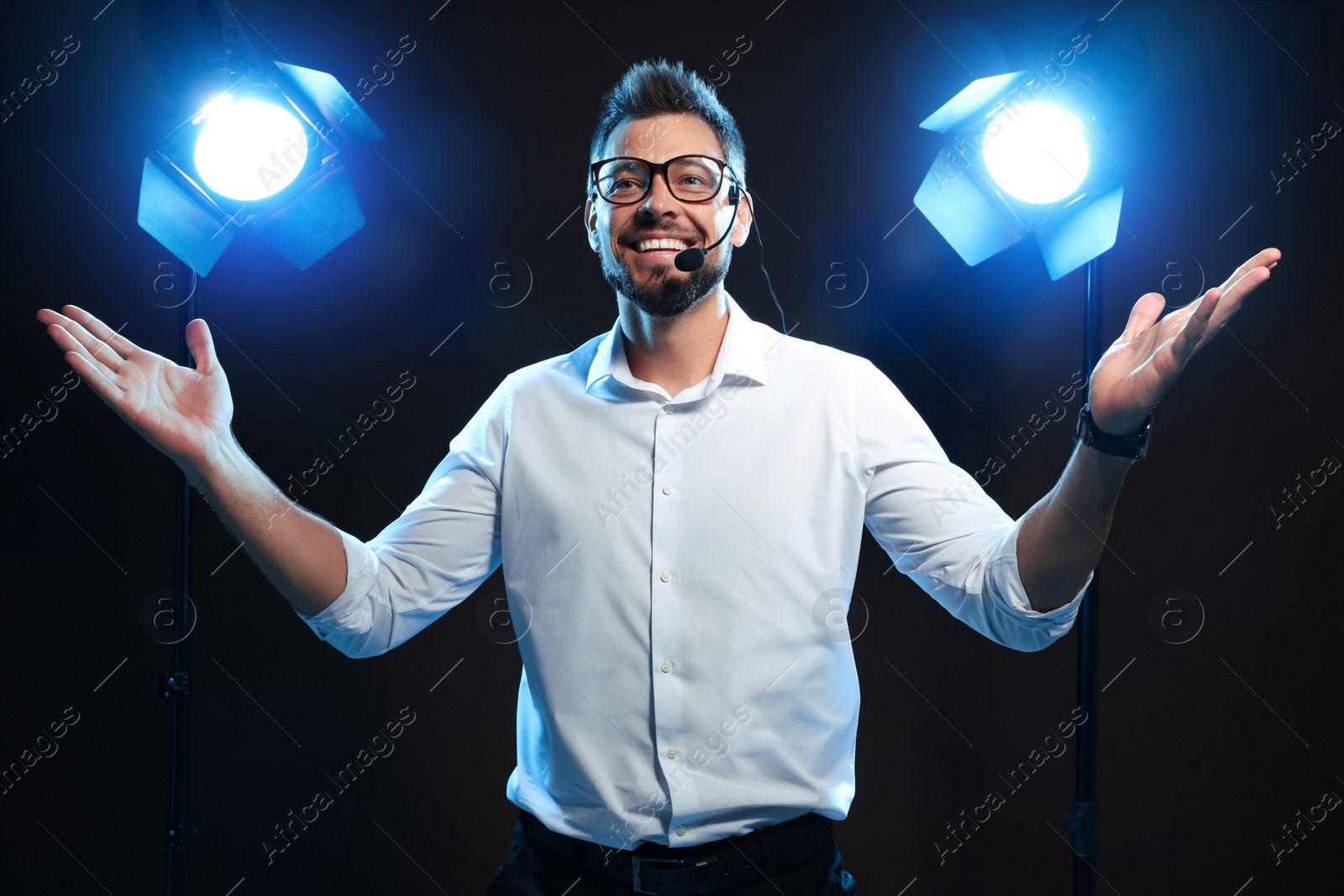 Photo of Motivational speaker with headset performing on stage