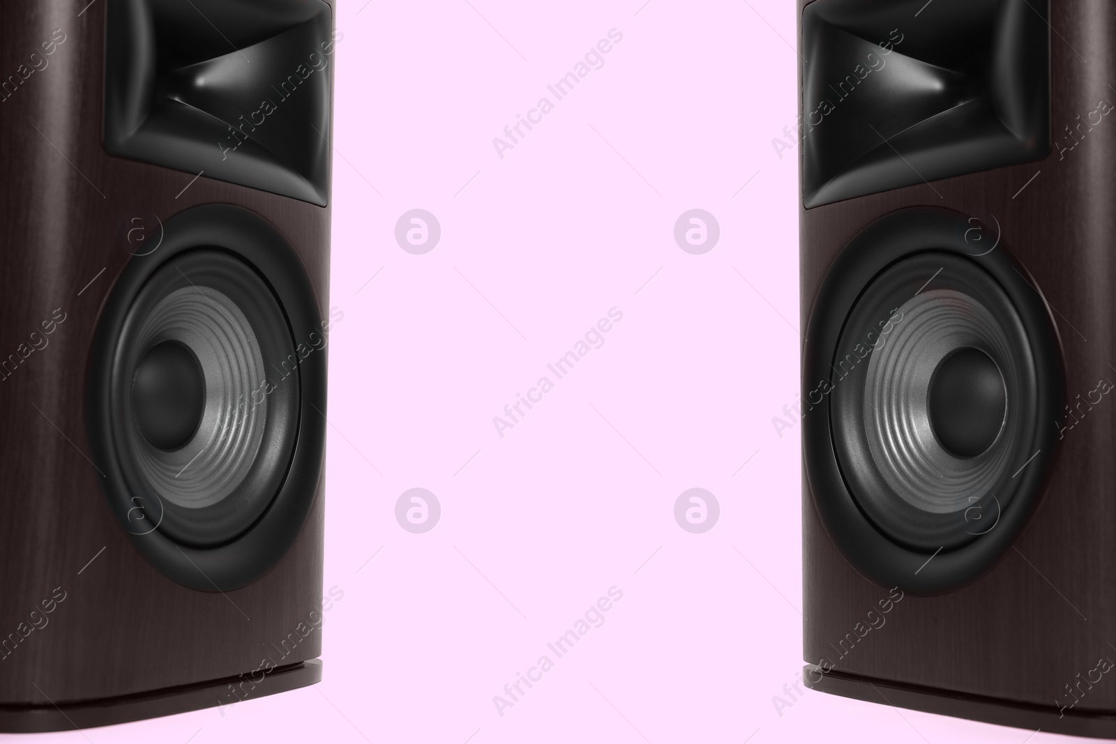 Photo of Wooden sound speakers on pink background. Space for text