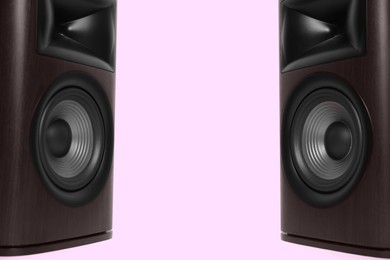 Photo of Wooden sound speakers on pink background. Space for text