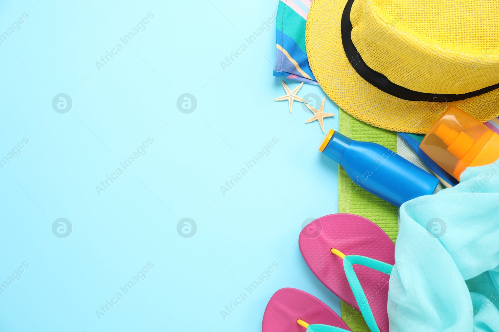 Photo of Flat lay composition with beach accessories on light blue background, space for text