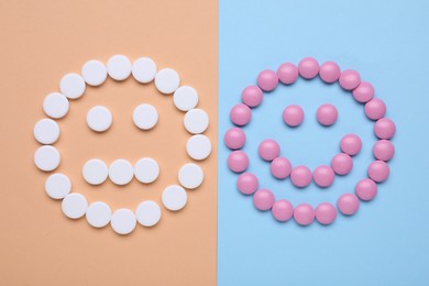 Photo of Happy and sad faces made of antidepressant pills on color background, flat lay