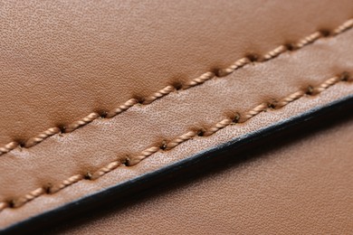 Brown natural leather with seam as background, above view