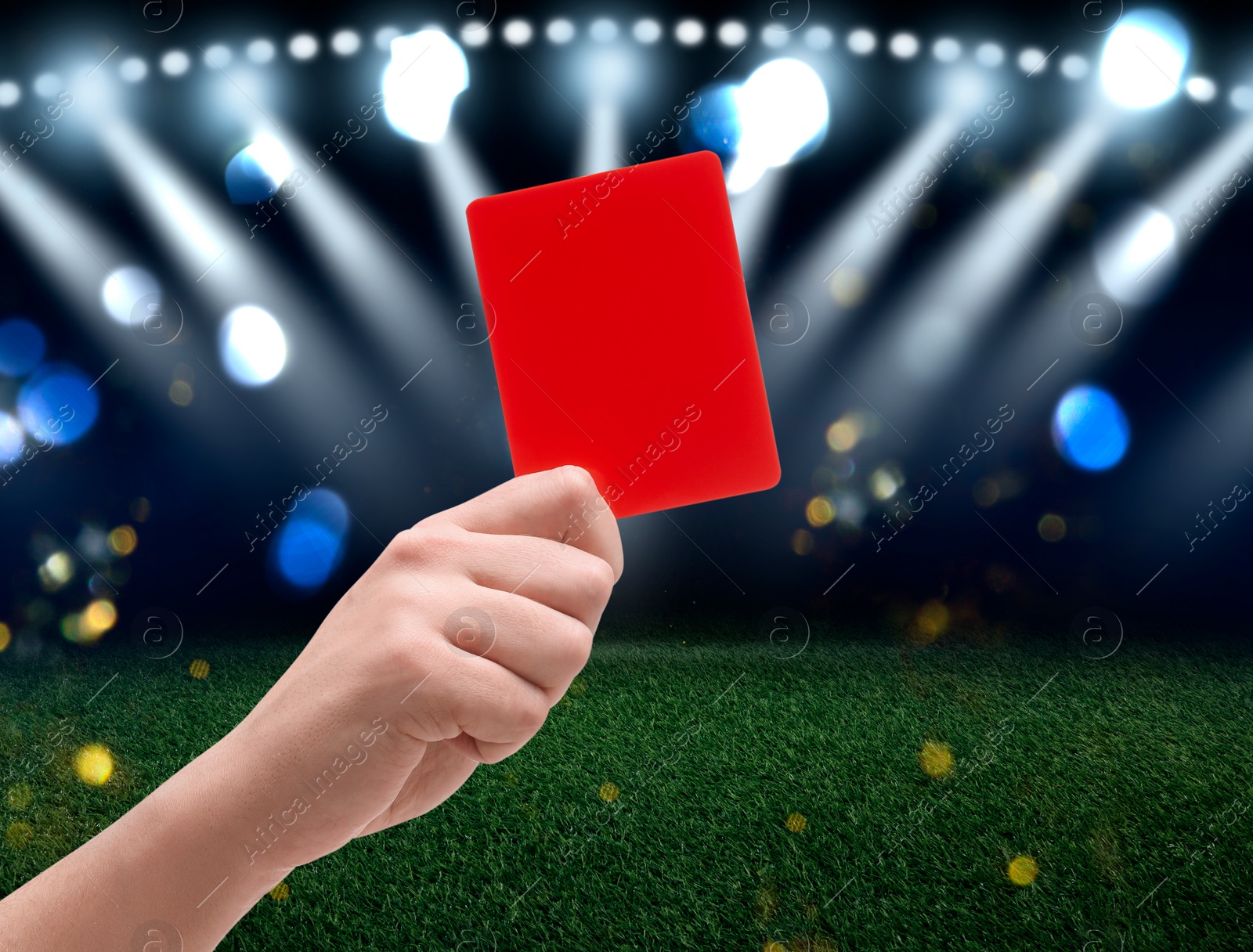 Image of Referee holding red card at stadium, closeup