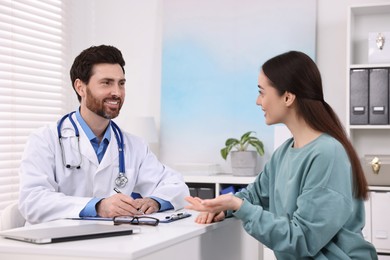 Photo of Doctor consulting patient during appointment in clinic