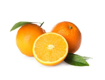 Photo of Cut and whole fresh ripe oranges with green leaves on white background