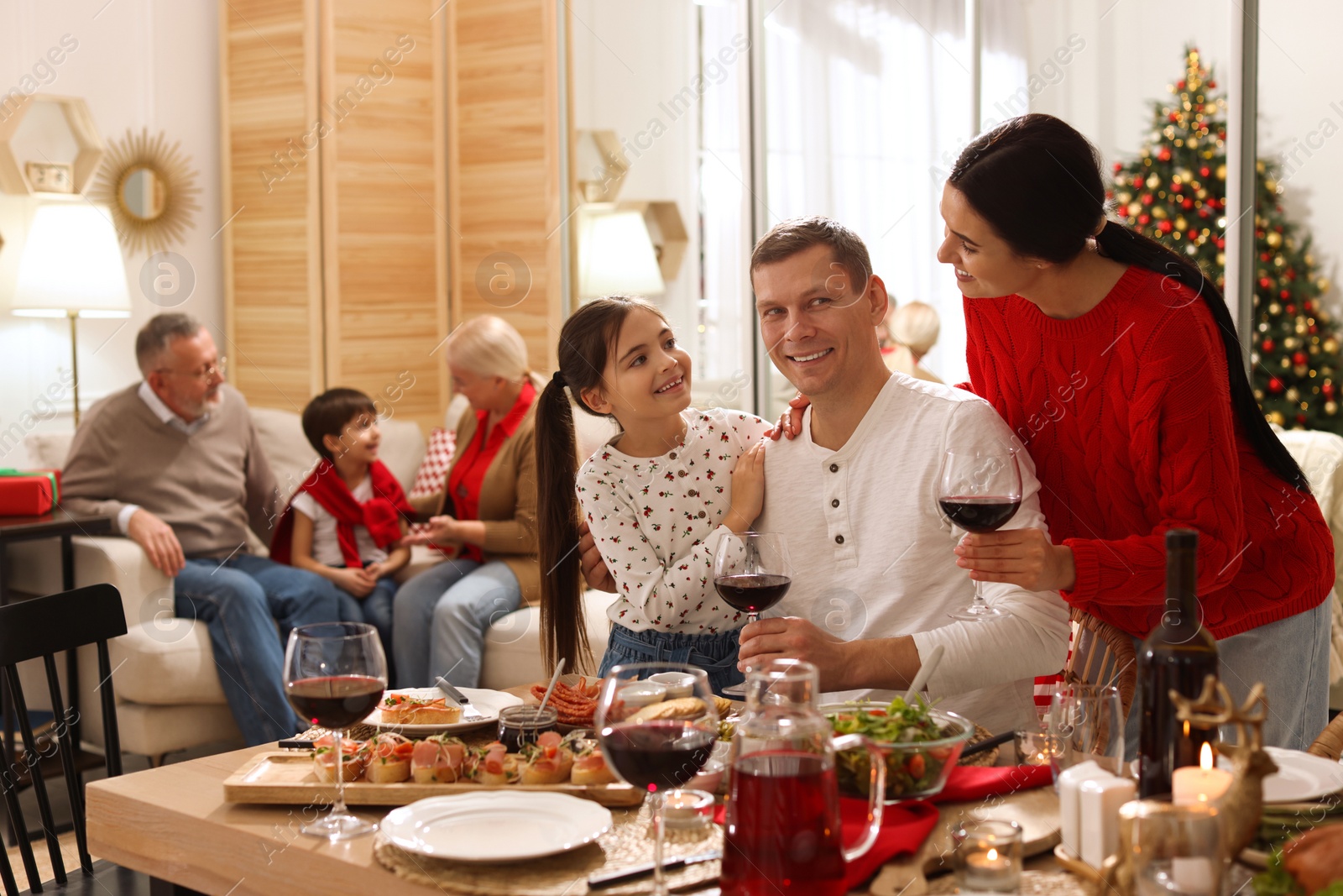 Photo of Happy family enjoying festive dinner at home. Christmas celebration