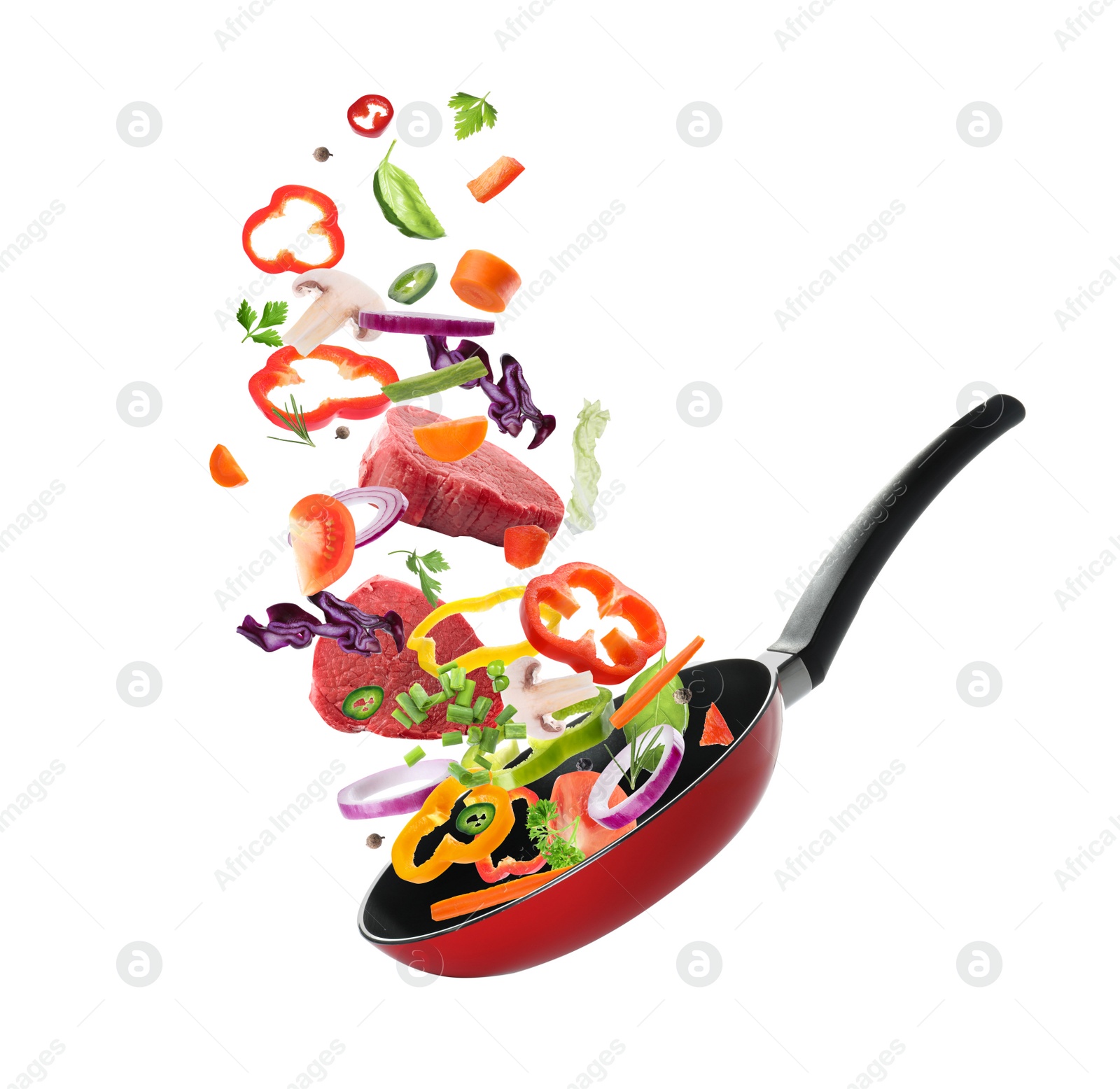 Image of Different vegetables and beef slices falling into frying pan on white background. Process of cooking