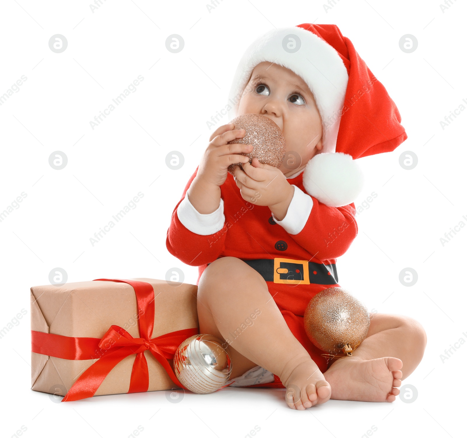 Photo of Festively dressed little baby with Christmas gift on white background