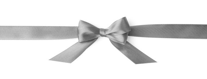 Grey satin ribbon with bow on white background, top view