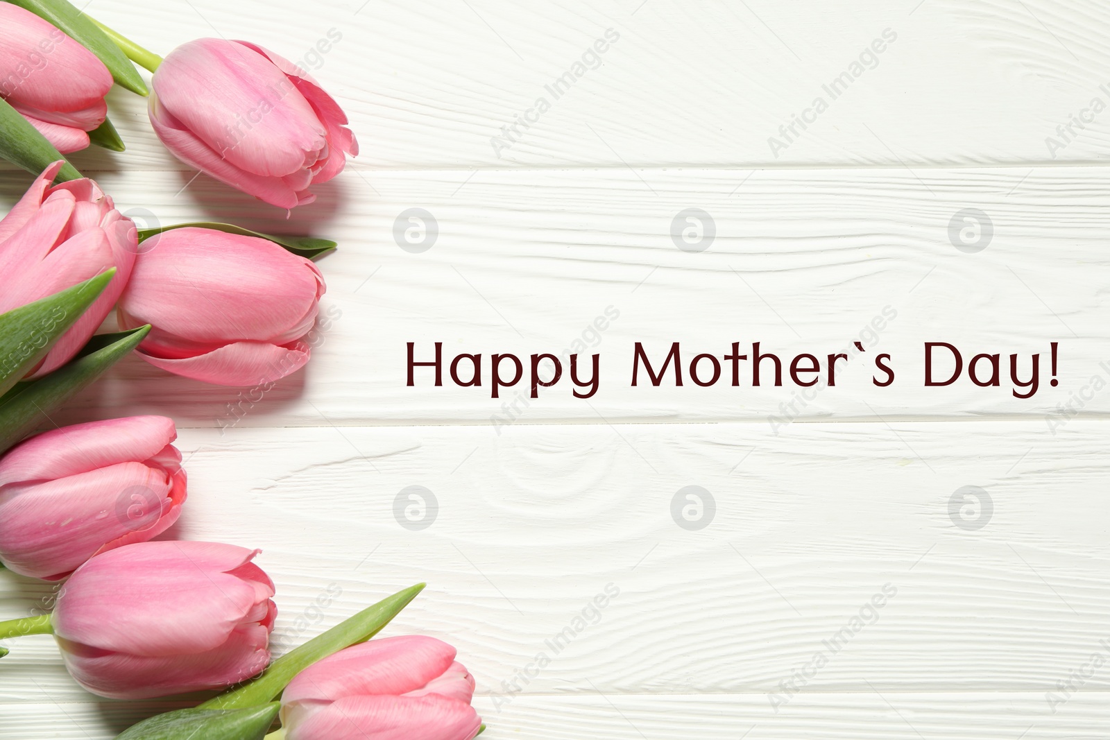 Image of Happy Mother's Day greeting card. Beautiful tulip flowers on white wooden background
