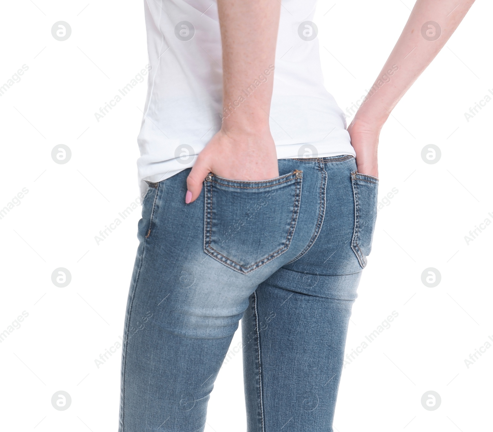 Photo of Young woman in stylish jeans on white background