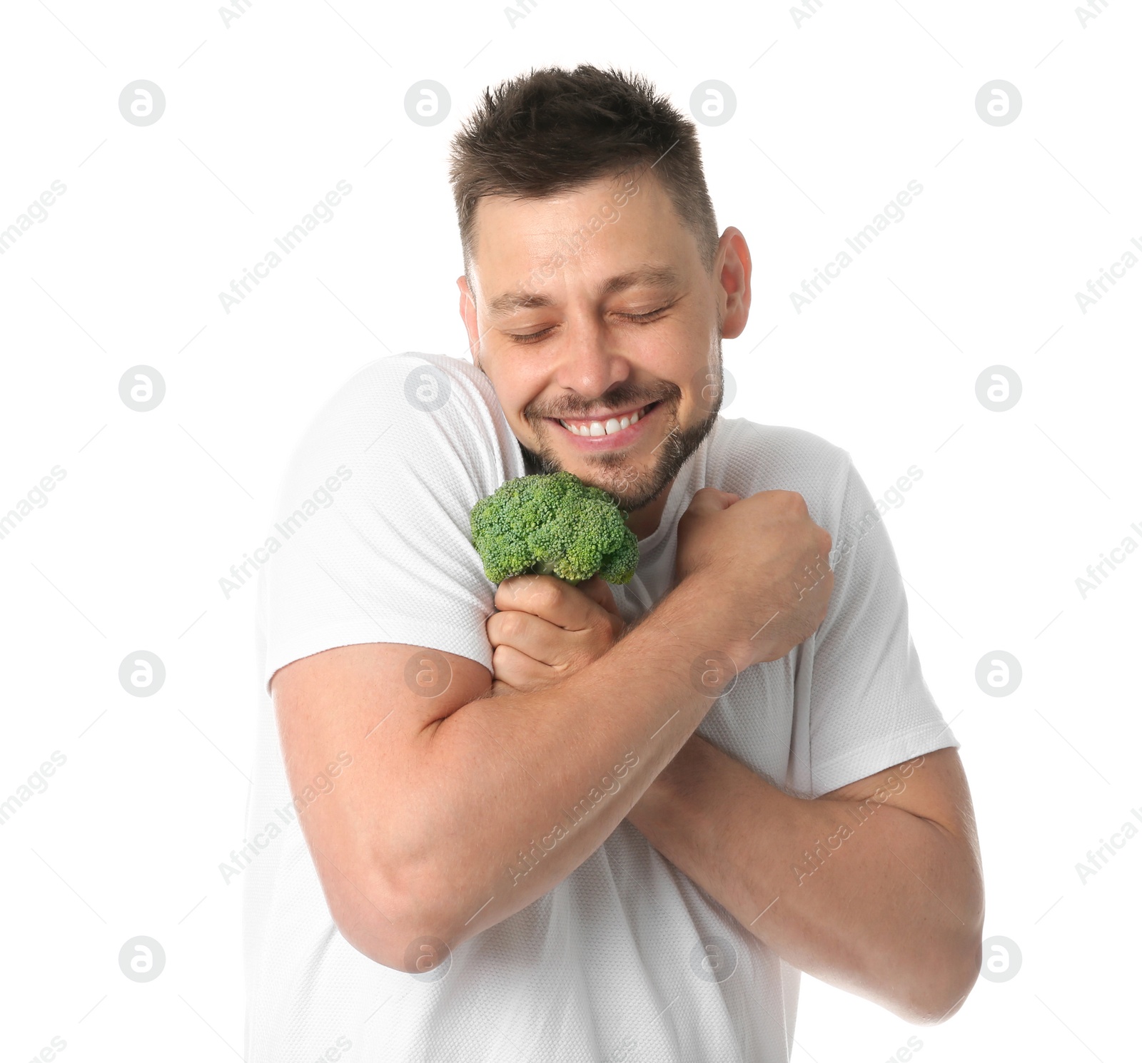 Photo of Portrait of happy man with broccoli on white background