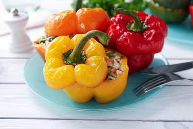 Photo of Tasty stuffed bell peppers on white wooden table