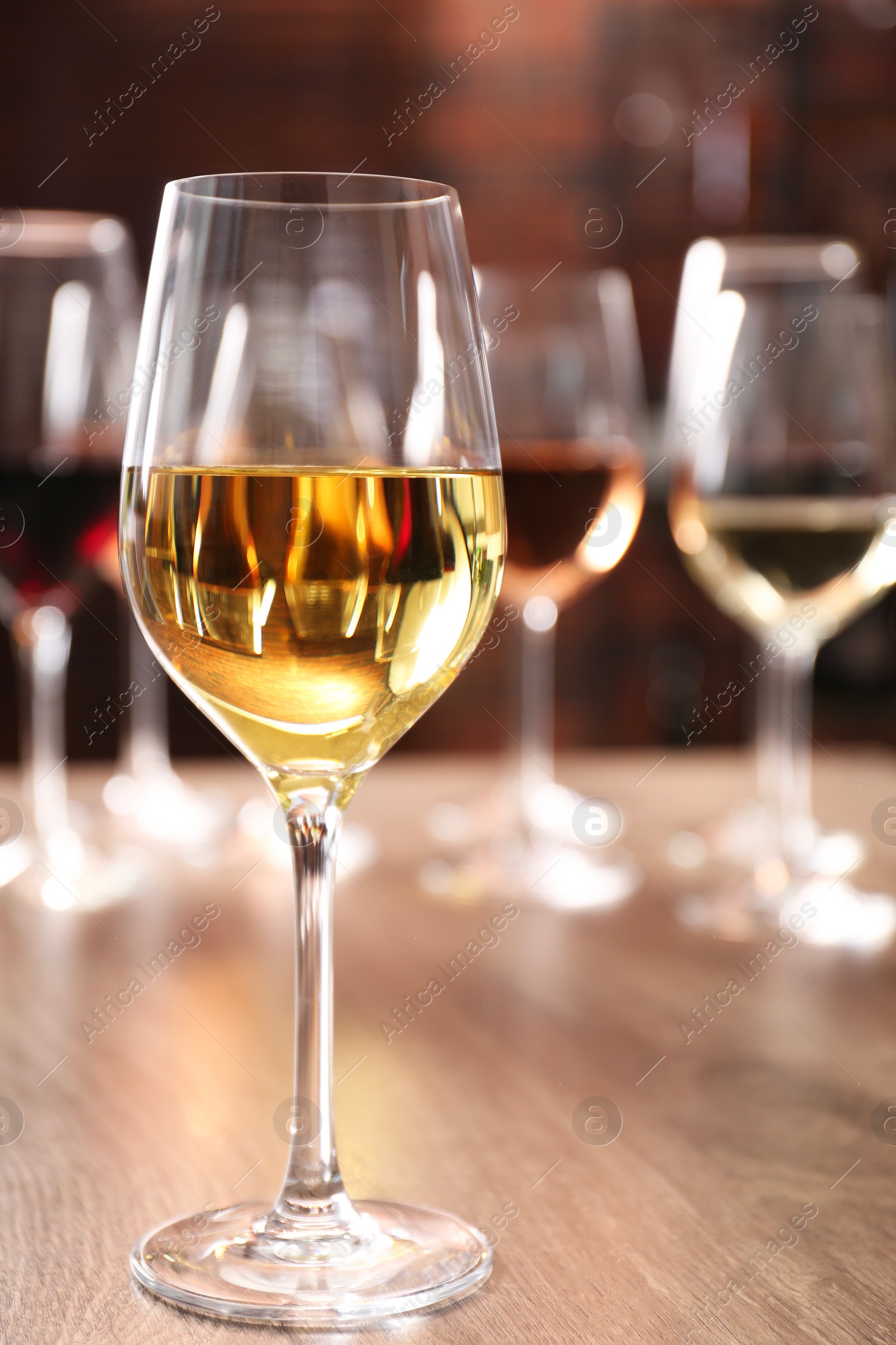 Photo of Tasty wine in glass on wooden table