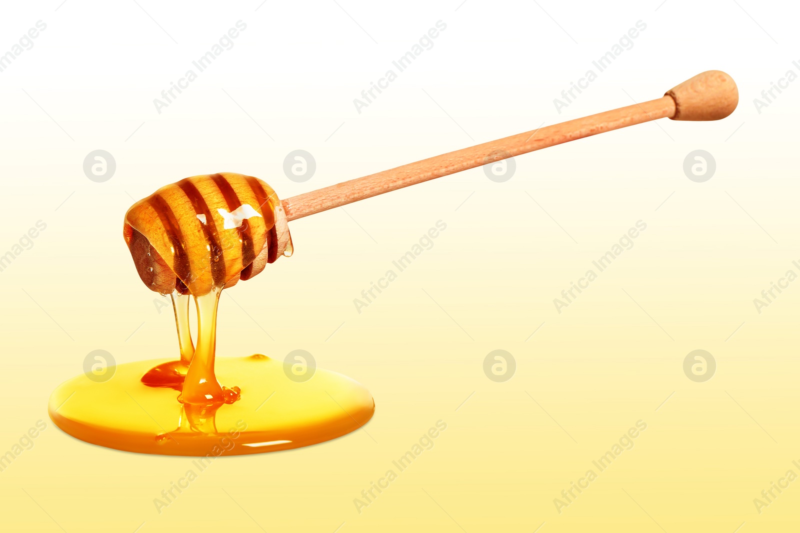 Image of Natural honey dripping from dipper on pale yellow background