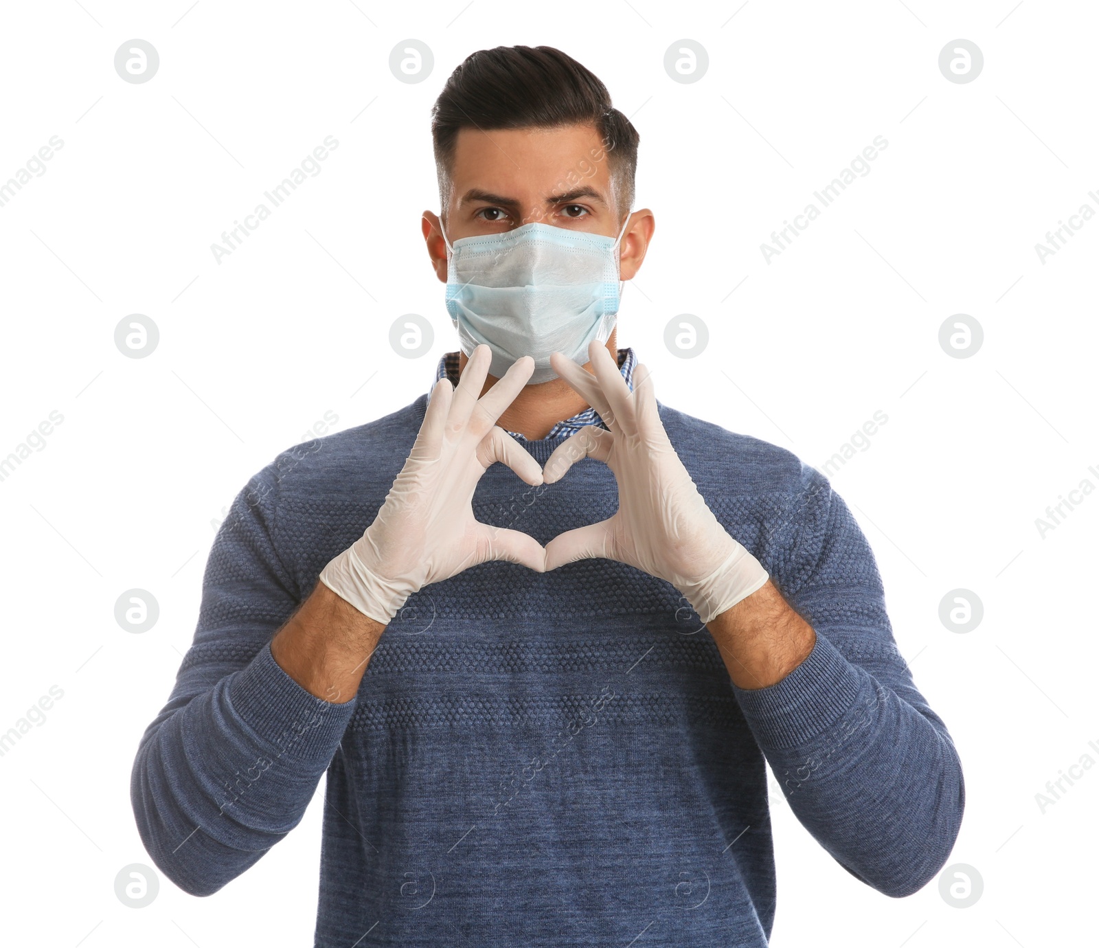 Photo of Man in protective face mask and medical gloves making heart with hands on white background