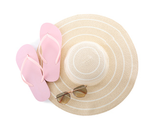 Pink flip flops, hat and sunglasses on white background, top view. Beach objects