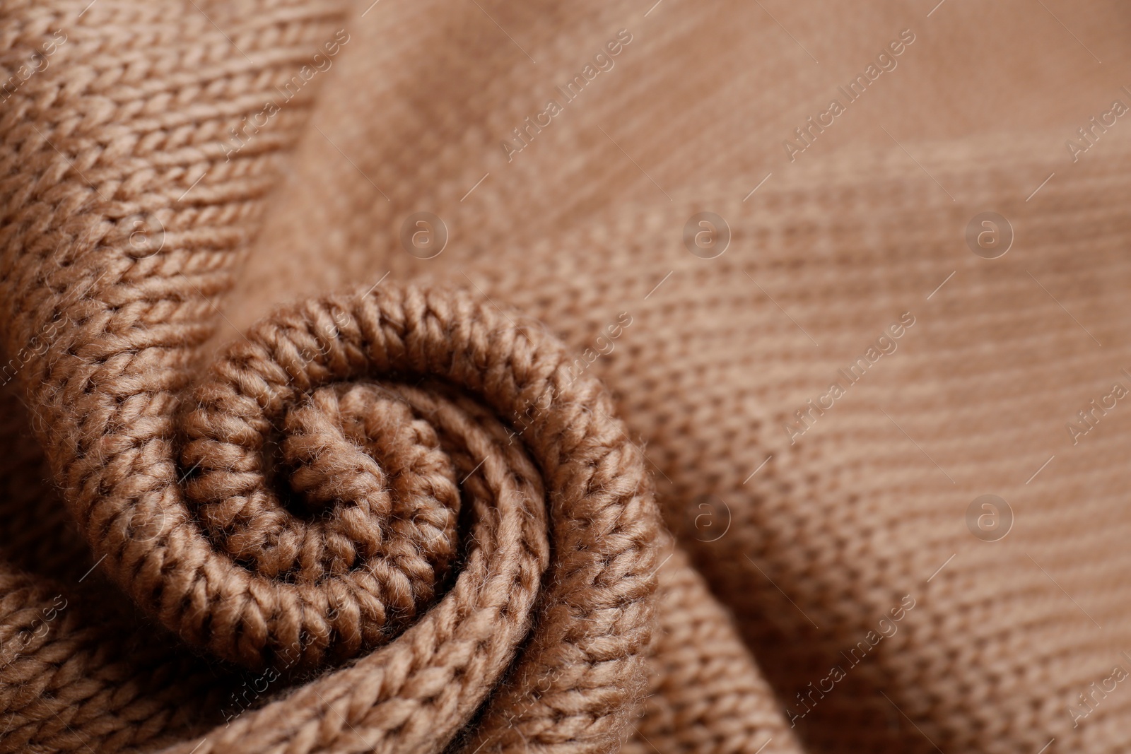 Photo of Brown knitted fabric as background, closeup view