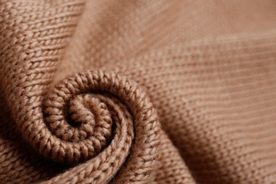Brown knitted fabric as background, closeup view