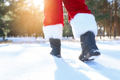Photo of Authentic Santa Claus walking outdoors, focus on legs