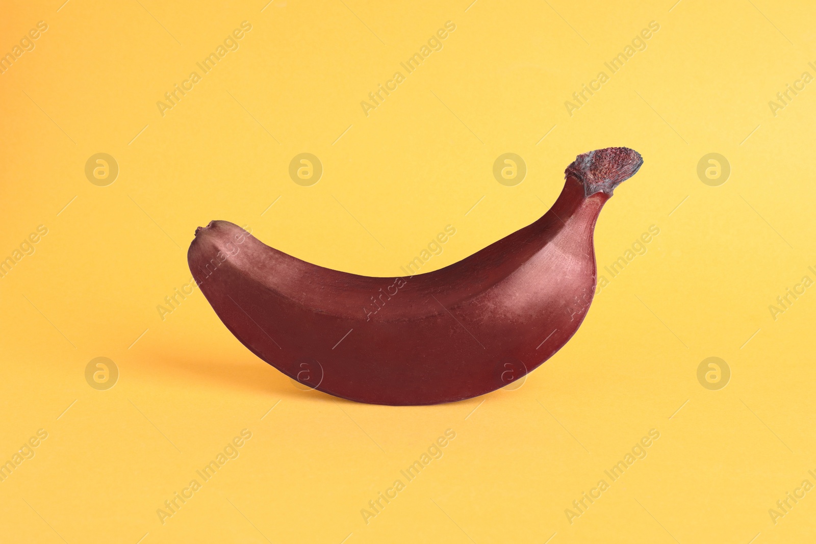 Photo of Tasty red baby banana on yellow background