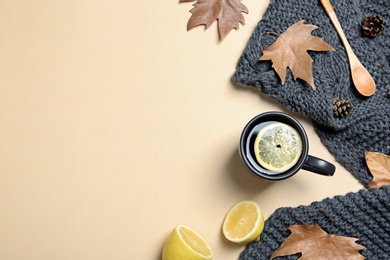 Flat lay composition with hot cozy drink and autumn leaves on color background. Space for text