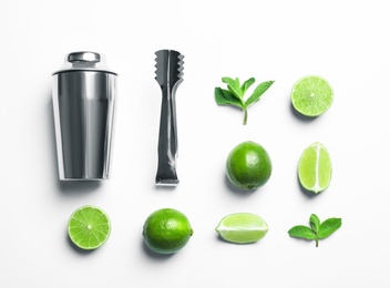 Flat lay composition with lime, mint and shaker on light background. Refreshing beverage ingredients